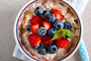 tazza di porridge con fragole e mirtilli