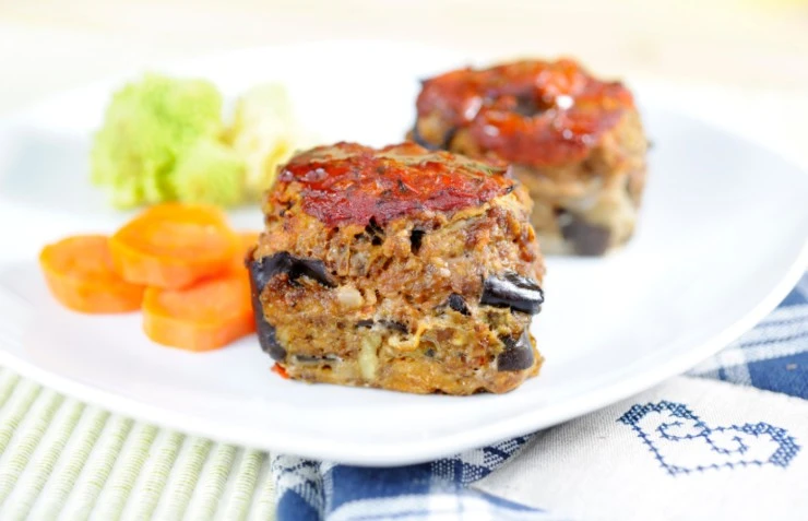 polpette di melanzane in un piatto con accanto carote e broccoli
