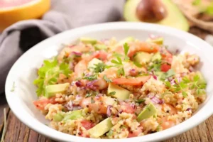 Piatto con orzo, gamberi, pomodori e avocado