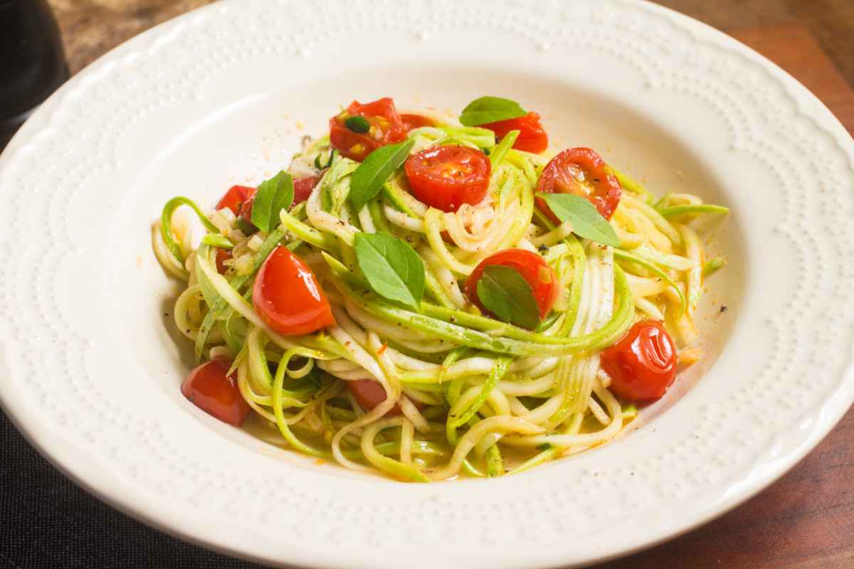 Piatto di spaghetti di zucchine con pomodorini