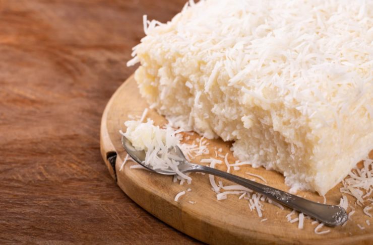 torta al cocco su un tagliere con accanto un cucchiaino