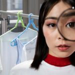 vestiti stesi e donna con lente di ingrandimento
