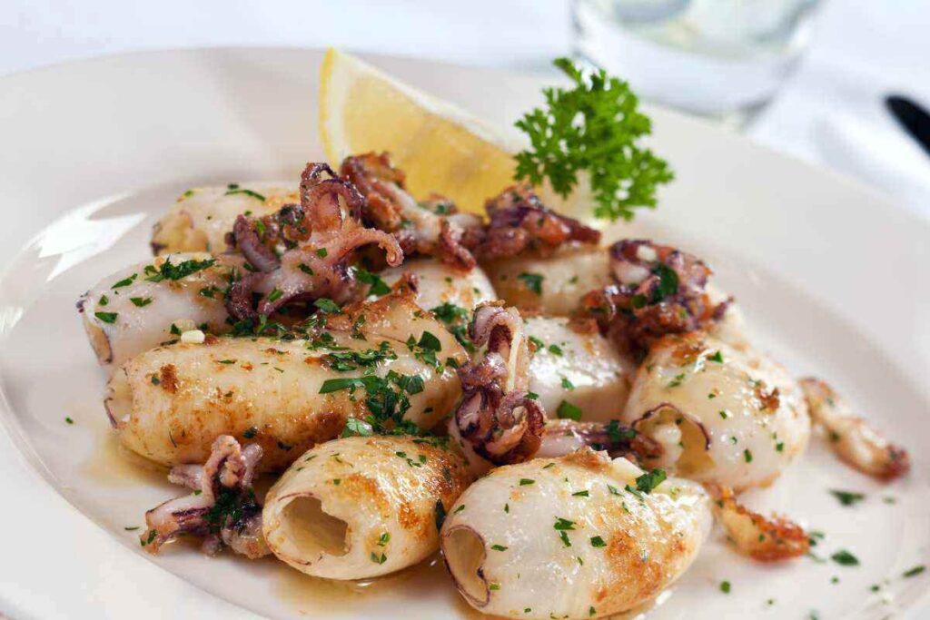 piatto di calamari in padella con prezzemolo