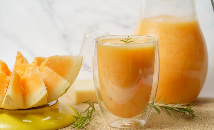 Fette di melone e succo nella brocca e nel bicchiere