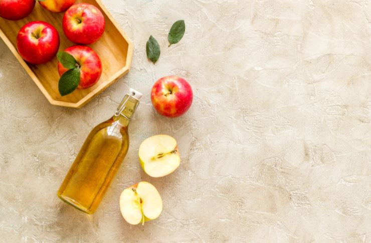 mele e bottiglietta di aceto