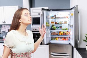 frigo aperto e ragazza annusa