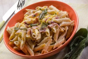 piatto di pasta con ricotta, speck e scorza di limone