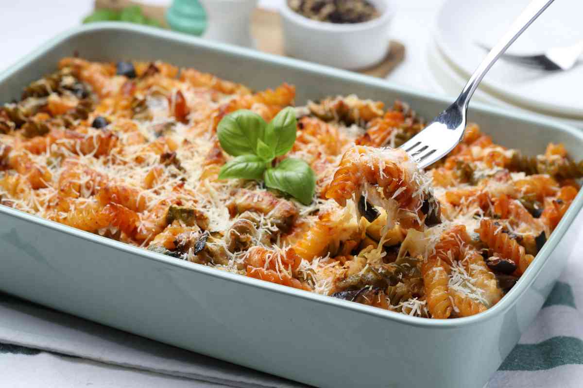 Teglia con pasta al forno, melanzane e foglie di basilico